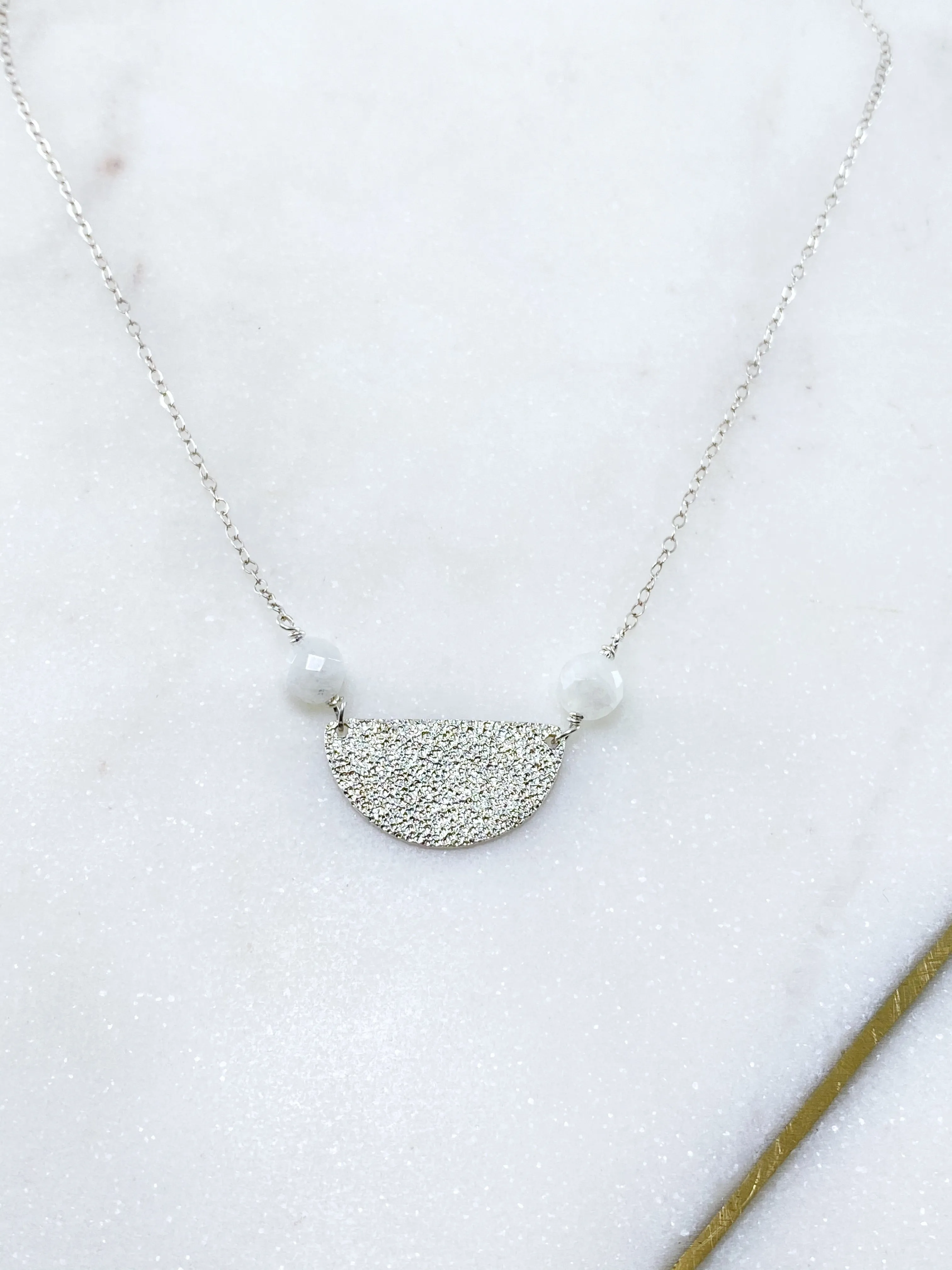 Sterling silver hammer textured half circle necklace with moonstone.